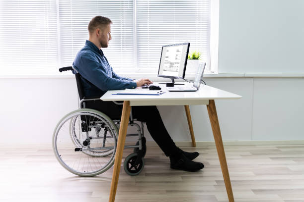 istock Businessman Sitting On Wheelchair And Using Computer 1213741282