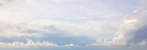 istock Blue sky clouds background. Beautiful landscape with clouds and orange sun on sky 1213742047