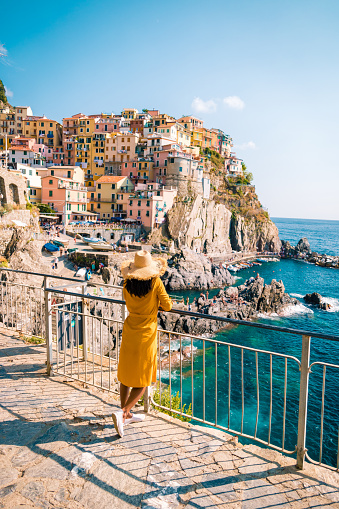 woman visit Manarola Village, Cinque Terre Coast Italy. Manarola is a beautiful small colorful town province of La Spezia, Liguria, north of Italy and one of the five Cinque terre national park Italy