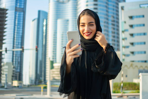istock Middle eastern woman using mobile phone outdoors 1213742296