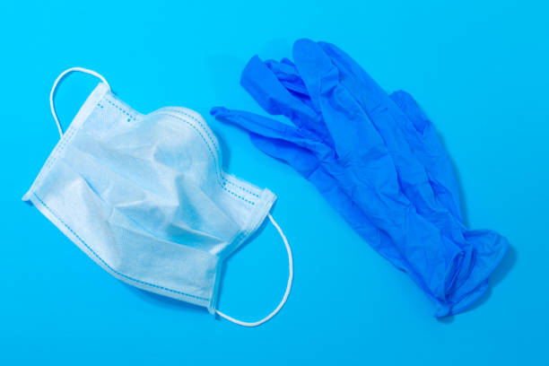 istock medical mask and gloves on a blue background 1213742952