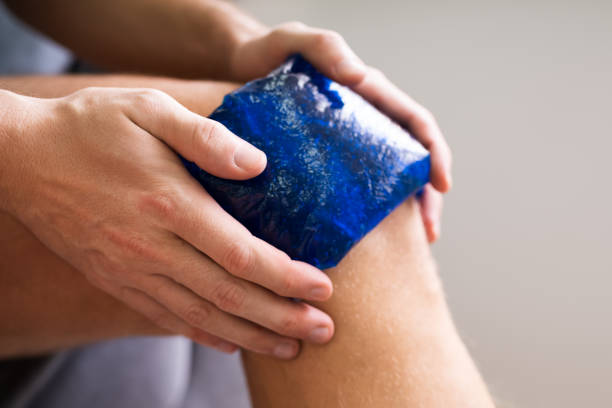 istock Hand Holding Ice Gel Pack On Knee 1213744091