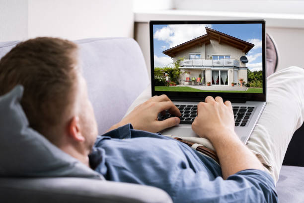 istock Man Selecting New House On Laptop At Home 1213744430