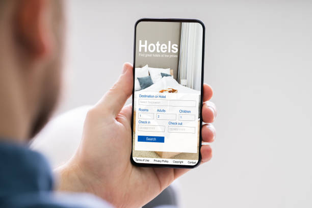 istock Person Booking Hotels Using Cell Phone 1213744481