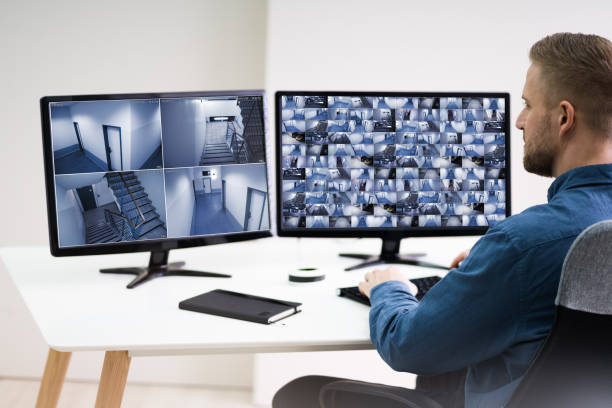 istock Man Monitoring CCTV Footage 1213744559