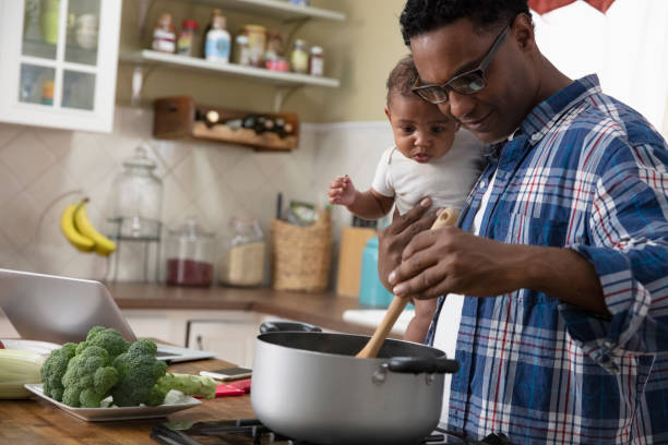 istock Father working from home holding baby 1213744598