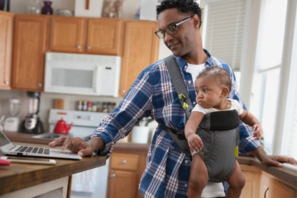 istock Single parent working from home holding baby 1213744623