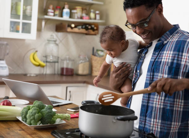 istock Father working from home holding baby 1213744624