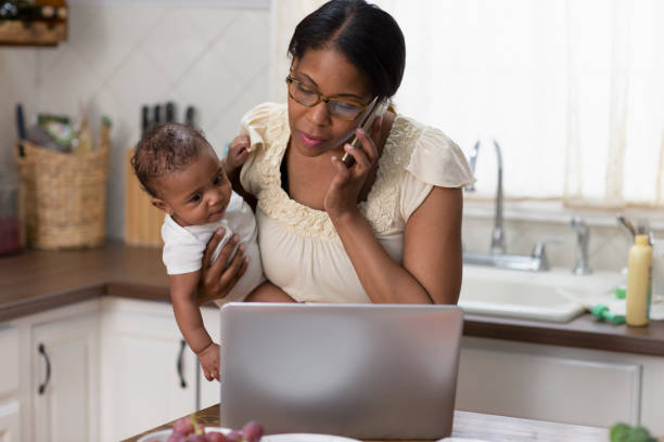 istock Single mother working from home holding baby 1213744762