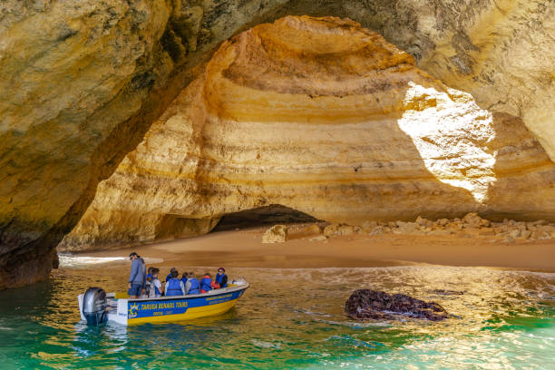 Benagil cave. Algarve coast. Portugal This pic shows famous Benagil cave in Algarve coast. Portugal. Tourist boat and cave can be seen in the pic. The pic is taken in january 2020 in portugal. algar de benagil photos stock pictures, royalty-free photos & images