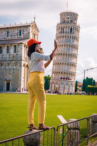woman visit pisa tower, Leaning tower of Pisa, Italy with Basilica and Cathedral on a bright summer day Italy