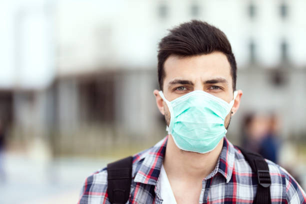 istock Men In Town Wearing Protective Face Mask 1213745662