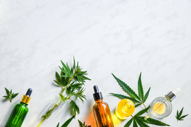Various glass bottles with CBD oil, THC tincture and hemp leaves on a marble background. Flat lay, minimalism. Cosmetics CBD oil Various glass bottles with CBD oil, THC tincture and hemp leaves on a marble background. Flat lay, minimalism. Cosmetics CBD oil. tincture photos stock pictures, royalty-free photos & images