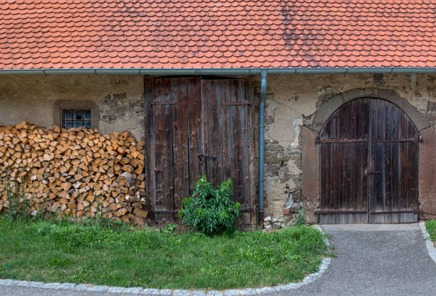 istock Old farm building with two gates 1213746772