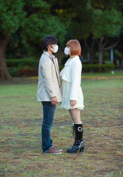 istock Young japanese couple with masks 1213752079