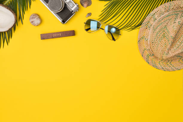 Summer composition with beach accessories, on yellow background. Top view, copy space. Flat lay. stock photo