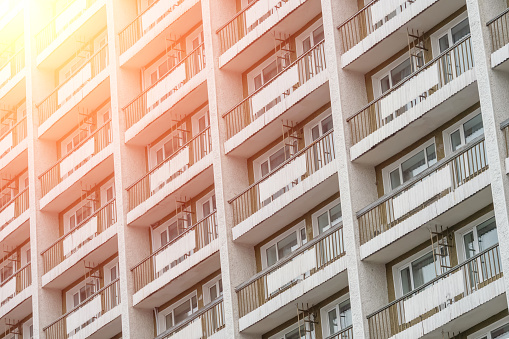 Balconies of a multi-storey residential building. urban background. Photo with illumination