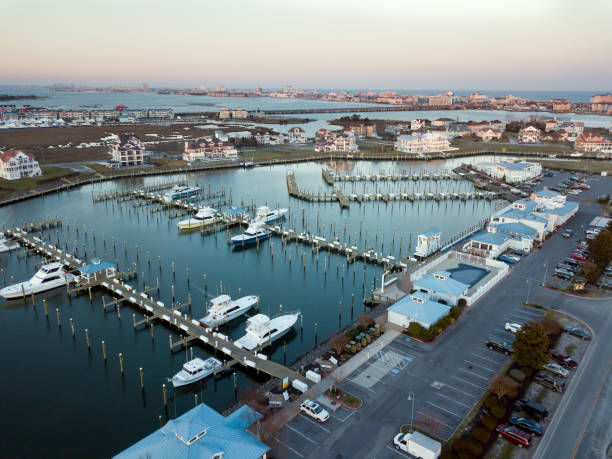 Aerial view of fishing marina in Ocean City, Maryland, USA. Fishing boats moored at a commercial fishing marina in Ocean City Maryland. ocean city skyline from the air stock pictures, royalty-free photos & images