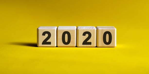 istock 2020 years on wooden cubes on a gradient yellow background 1213759489