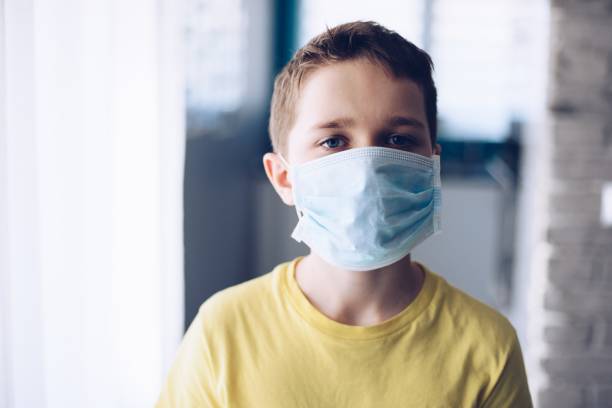 istock Child boy wearing protective medical mask during quarantine. 1213760496
