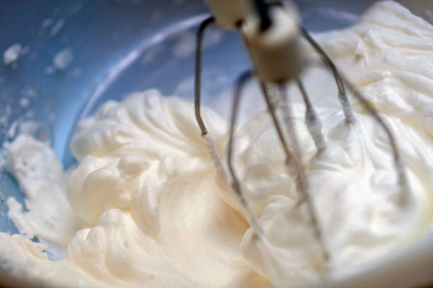 istock Mixing white egg cream in bowl with electric mixer, baking cake 1213760530