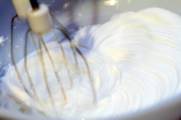 istock Mixing white egg cream in bowl with electric mixer, baking cake 1213760558