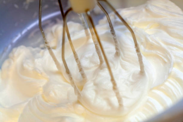 istock Mixing white egg cream in bowl with electric mixer, baking cake 1213760596