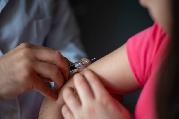 istock Doctor giving child patient injection 1213760722