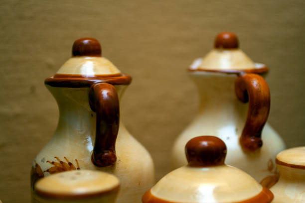 istock Old ceramic jars and kitchen utensils in front of a kitchen wall 1213760972