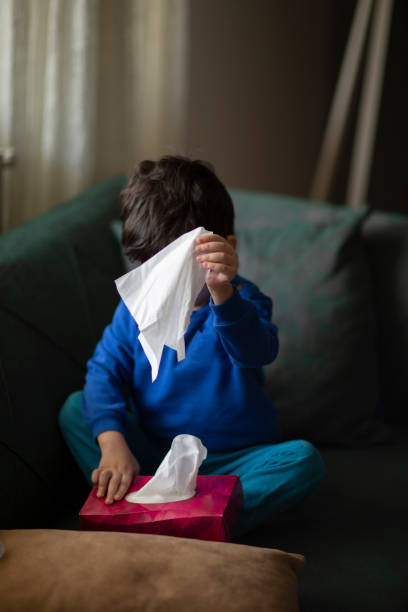 istock Smiling child  preschooler with a tissue for cold or rhinitis 1213763762