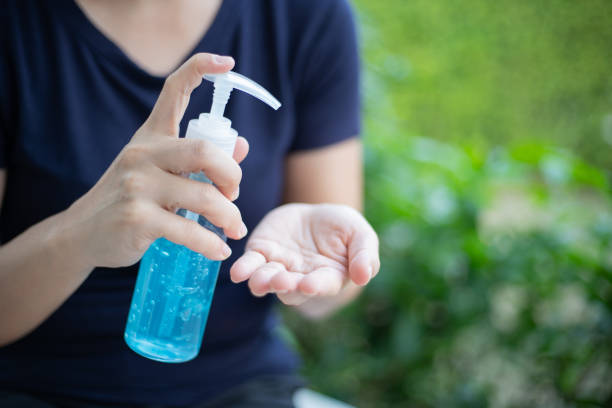 istock A woman using a hand sanitizer, alcohol gel at home 1213766407