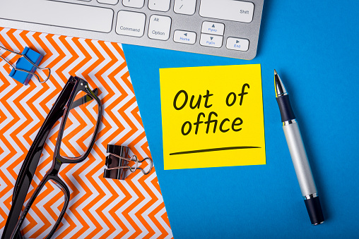 Out of office - memo on office workplace. Holiday Announcement, Day Off or Quarantine Covid-19.