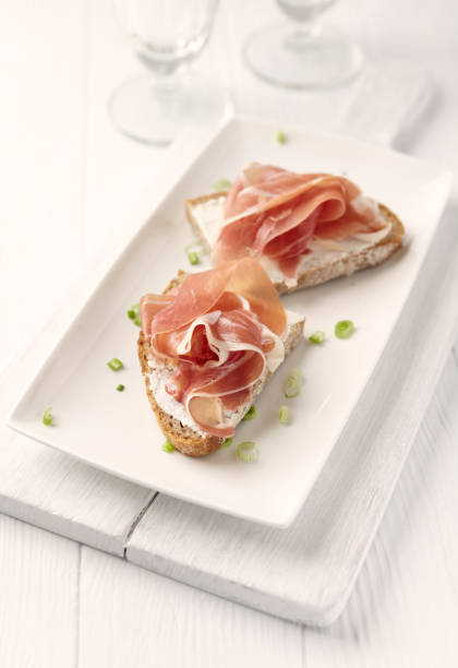 istock Sandwich with soft cheese and ham. Bright wooden background. 1213766826