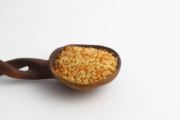 istock dry bulgur wheat in wooden spoon isolated on white background. top view 1213767608