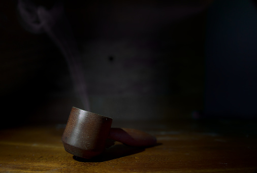 old wooden handmade pipe on a table