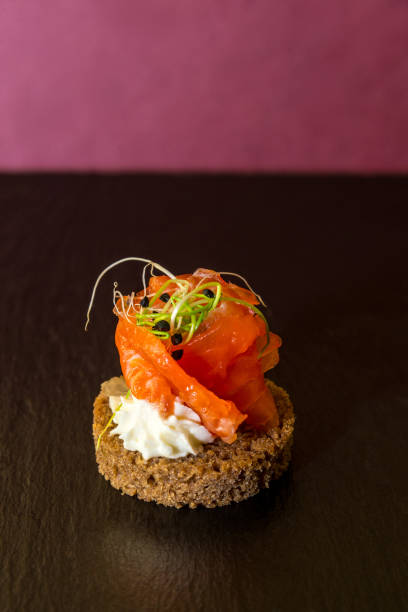 istock tasty canapes with seafood on a red background. Vertical frame 1213768507