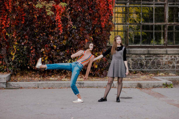 istock Beautiful students walking in the autumn park 1213770454