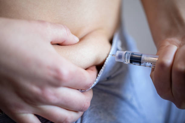 injecting insulin shot in stomach area - insulin diabetes pen injecting imagens e fotografias de stock