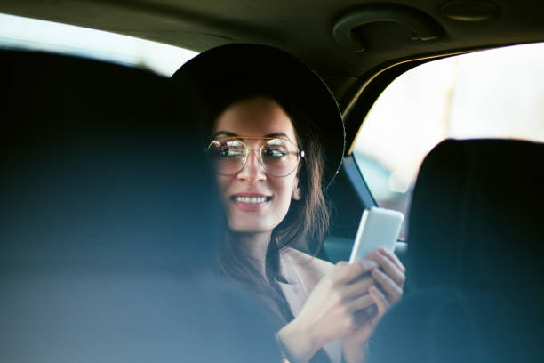 istock Woman using mobile phone in the car 1213774239