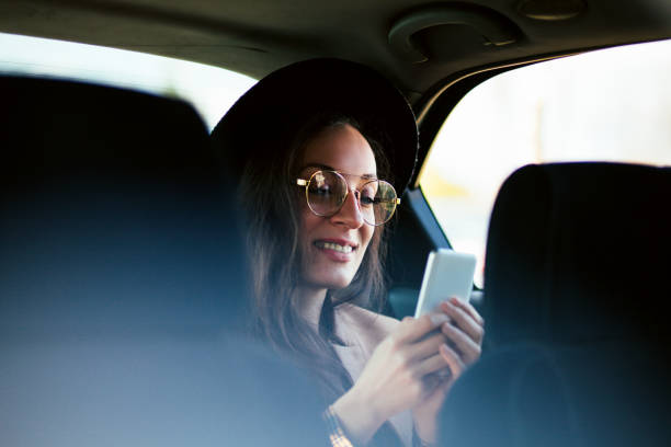 istock Woman using mobile phone in the car 1213775445