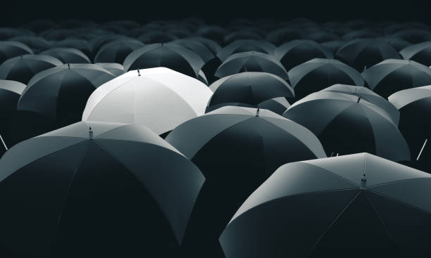 istock White umbrella in mass of black umbrellas 1213776518
