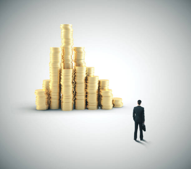 istock Businessman looking on pile gold coins. 1213777257