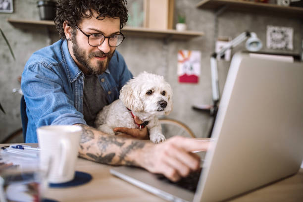 istock Young designer and his dog 1213780299