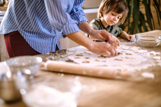 istock Mother Teaches Little Boy How to Make Gingerbread Cookies 1213781501
