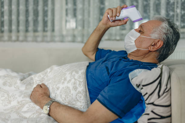 istock the patient under observation at home measures his fever 1213782463