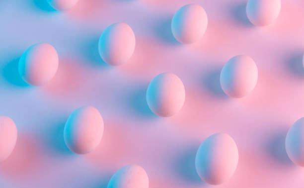 istock Creative simple geometrical pattern made of white chicken eggs. Creative minimal holographic Easter concept. 1213783540