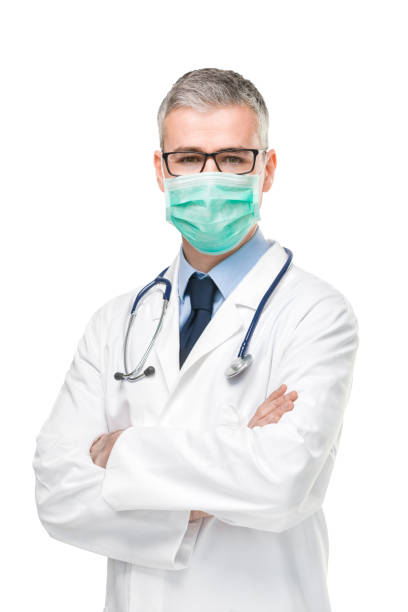 Doctor wearing a surgical mask against infections stock photo