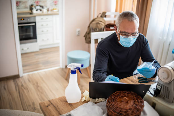 istock Senior man makes face masks 1213786206
