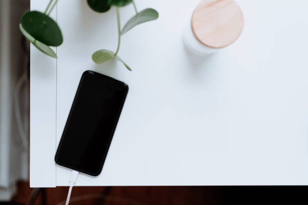 istock Cell phone being charged at home 1213788179
