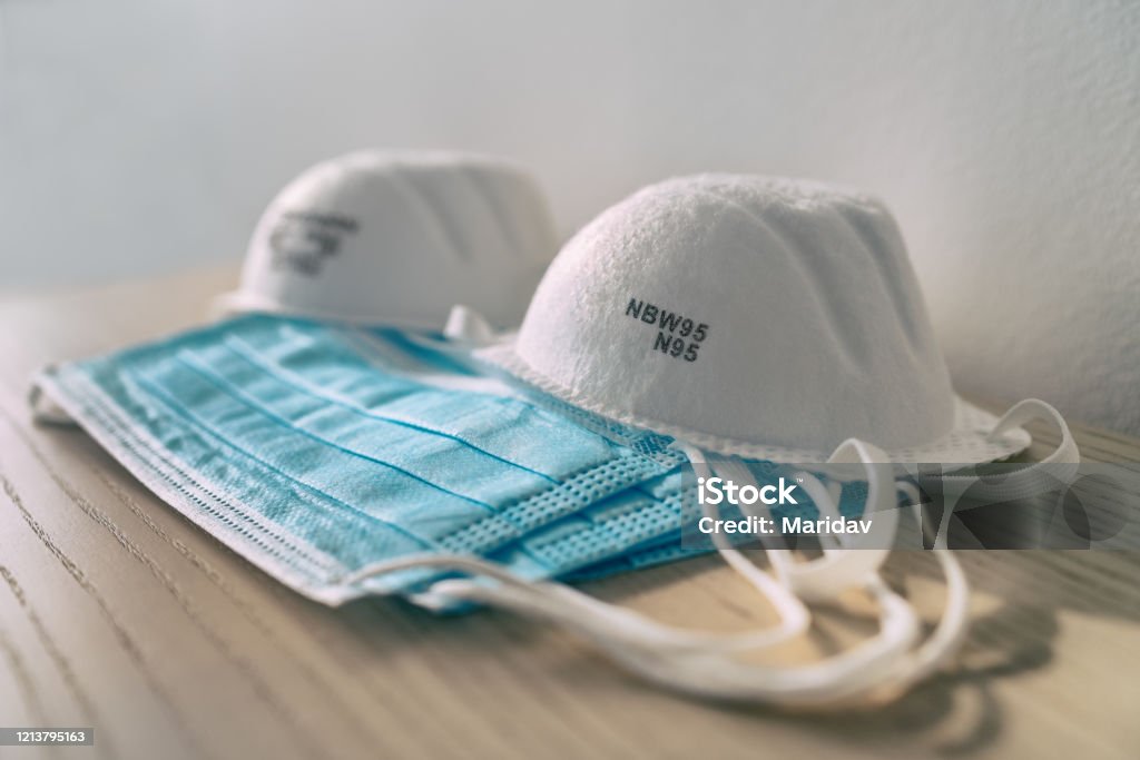 Corona virus prevention face mask protection N95 masks and medical surgical masks at home . Protective Workwear Stock Photo